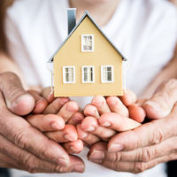Family holding house in hands Family holding house in hands. Moving and spring renovation concept